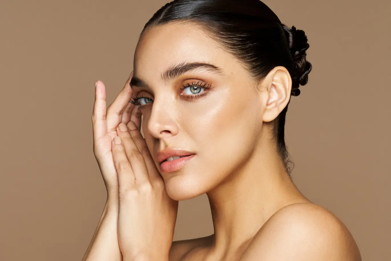 Woman with smooth skin on a beige background