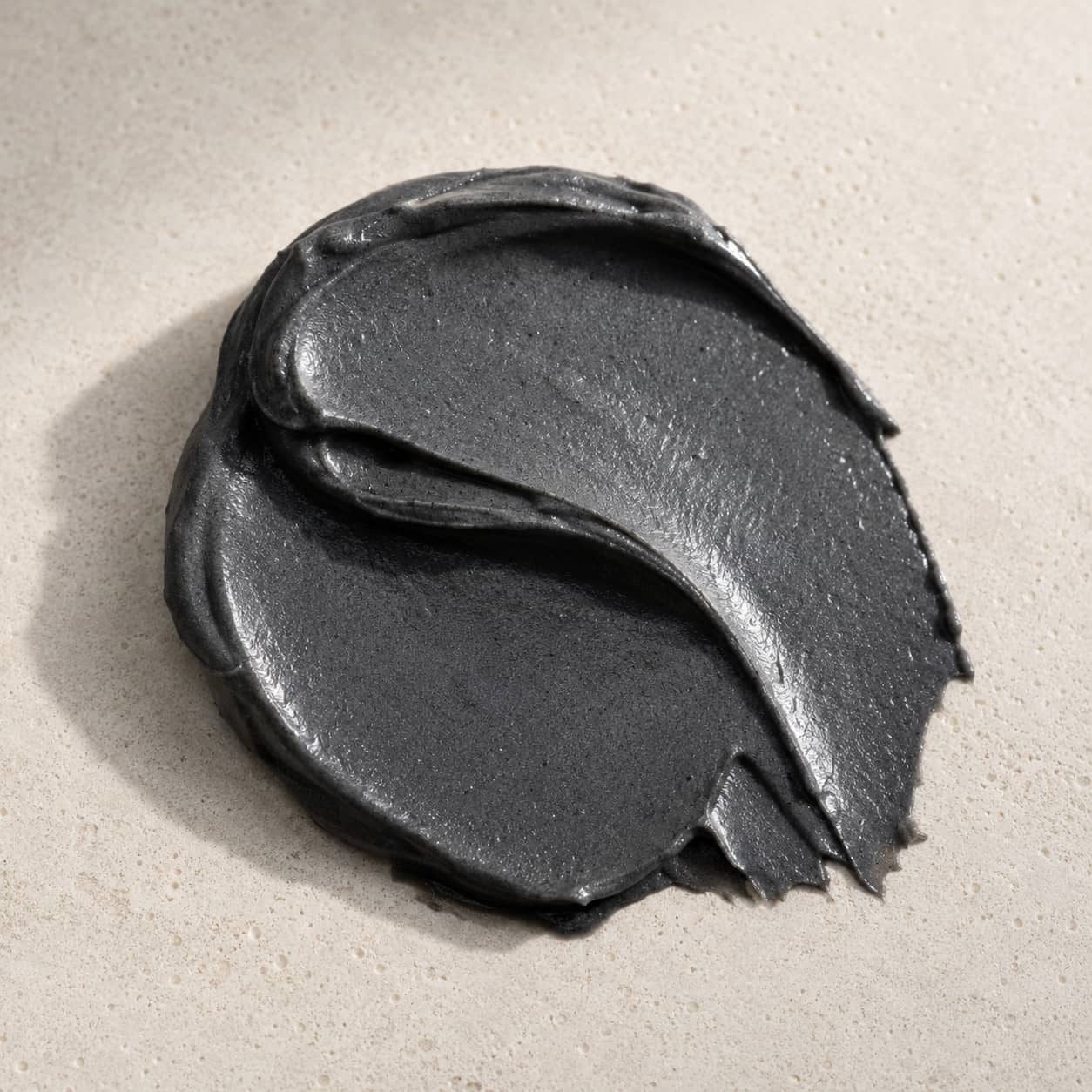MERAKKEE Purifying Charcoal Facial Mask — deep black mask texture swatch on white — Charcoal Neem Tea Tree formula