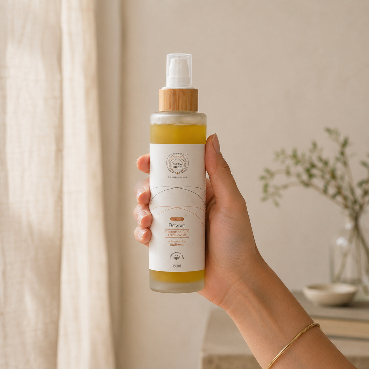 MERAKKEE Radiance 24K Face Wash 150ml — pump bottle held in hand size reference — Revive clean beauty